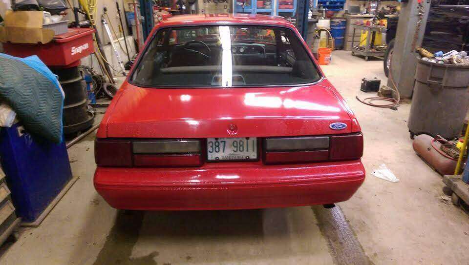 Rear view of a finished red Fox-body Ford Mustang