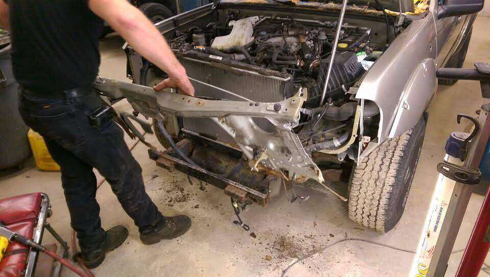 Damaged Nissan radiator support being removed