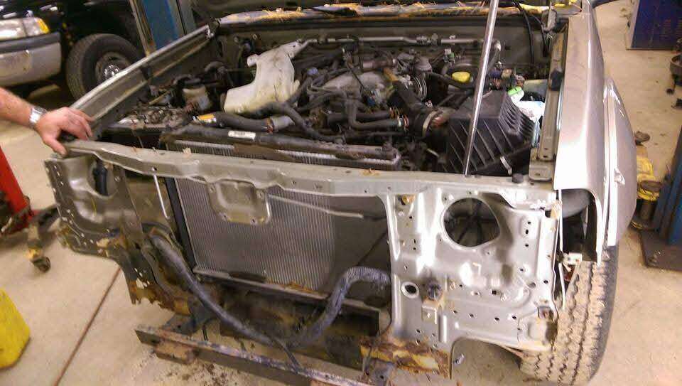 Replacement front support positioned on a Nissan truck