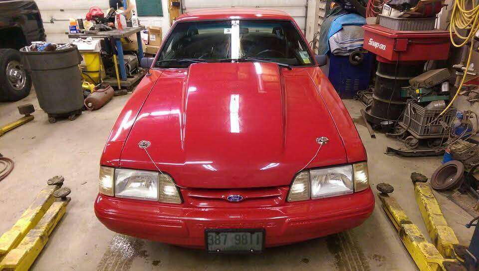 Front view of a red Fox-body Mustang