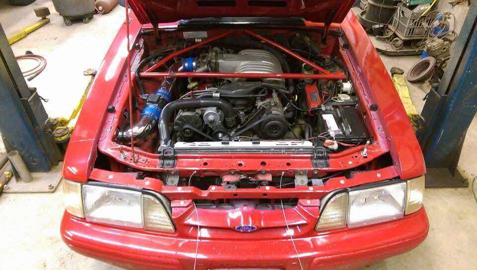 Performance hardware in a Fox-body Mustang engine bay