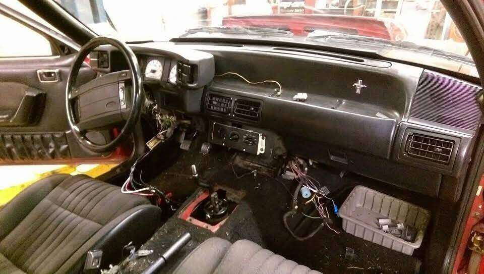 Fox-body Mustang dashboard opened for repair access