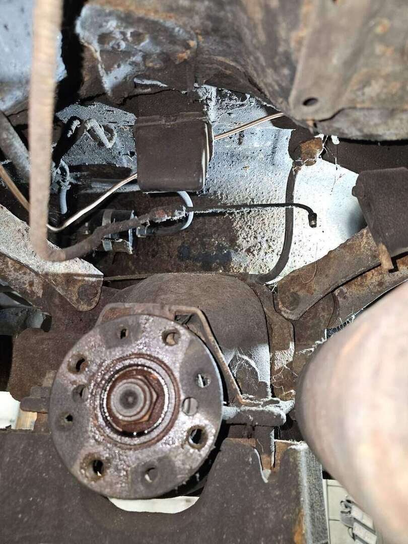 Replacement brake line routed near the rear wheel of a 1992 Ford Mustang GT