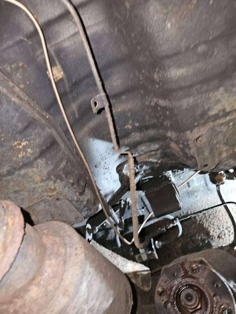 Detailed view of replacement brake-line routing on a Fox-body Mustang