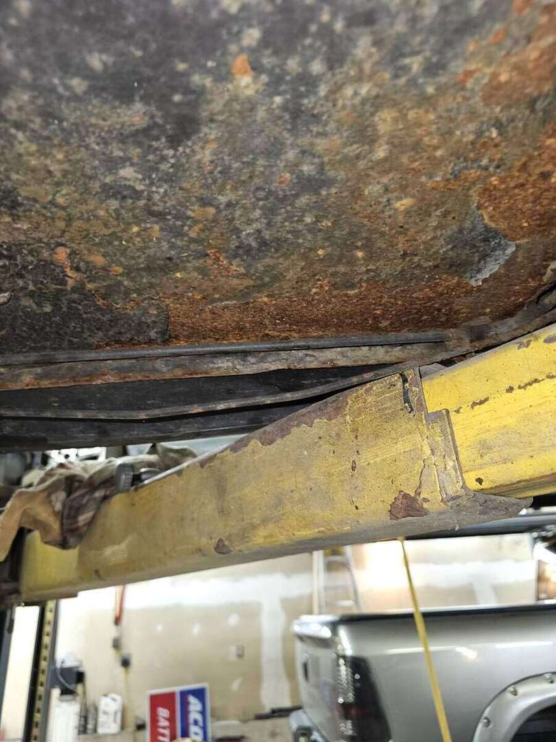 Original brake line routing beneath a 1992 Ford Mustang GT before repair