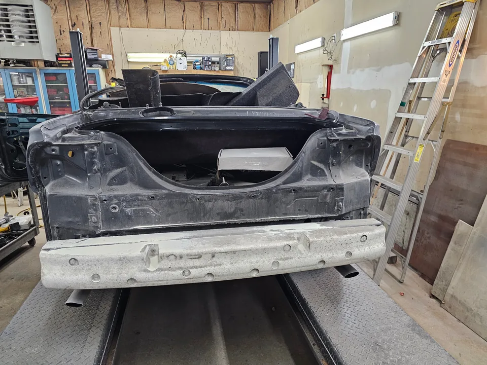 Rear of the 1997 Ford Mustang GT convertible with the trunk lid, tail lamps and bumper cover removed