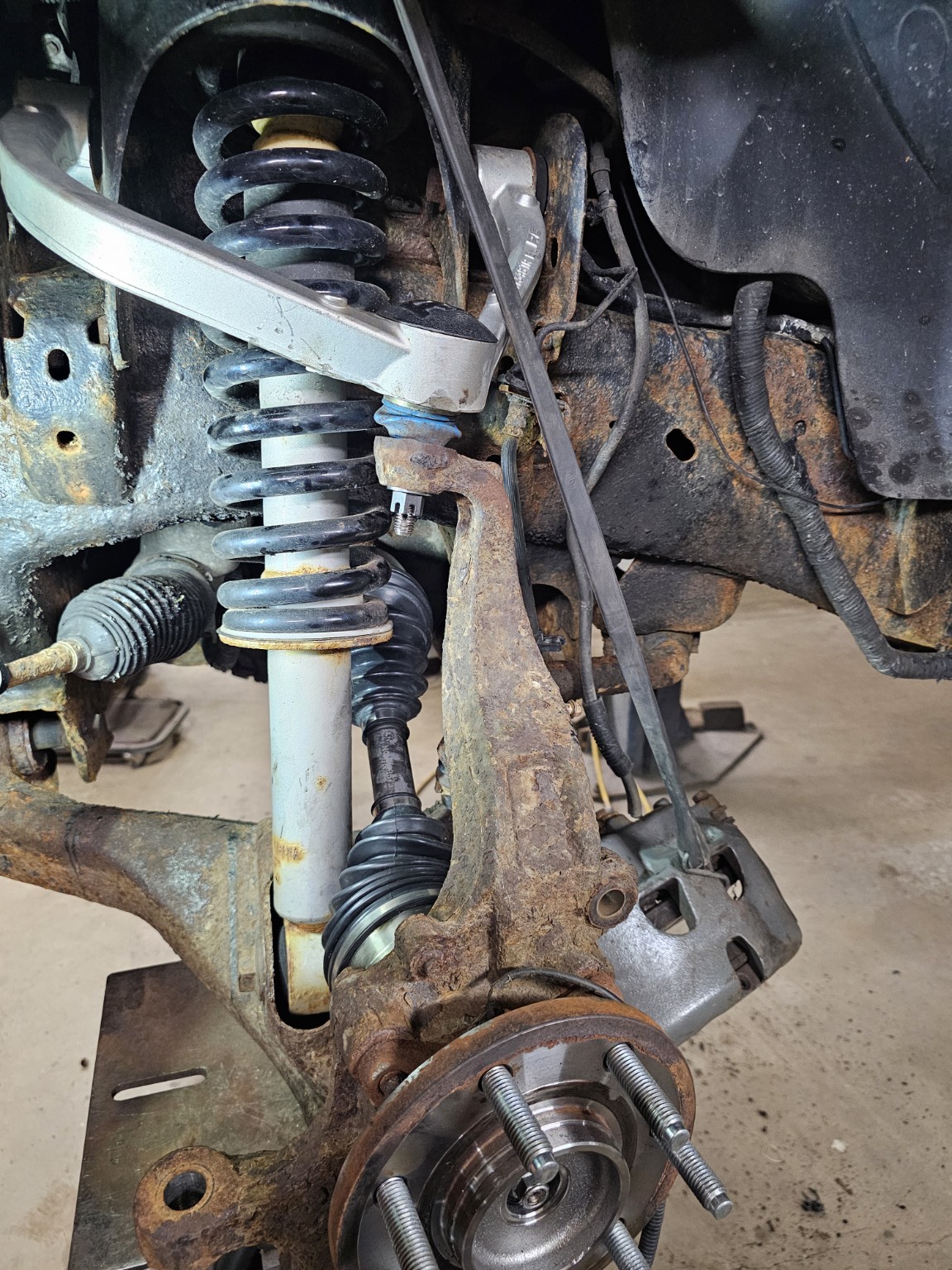 2011 Ford F-150 front suspension reassembly after upper ball joint and CV axle replacement in Raymond New Hampshire
