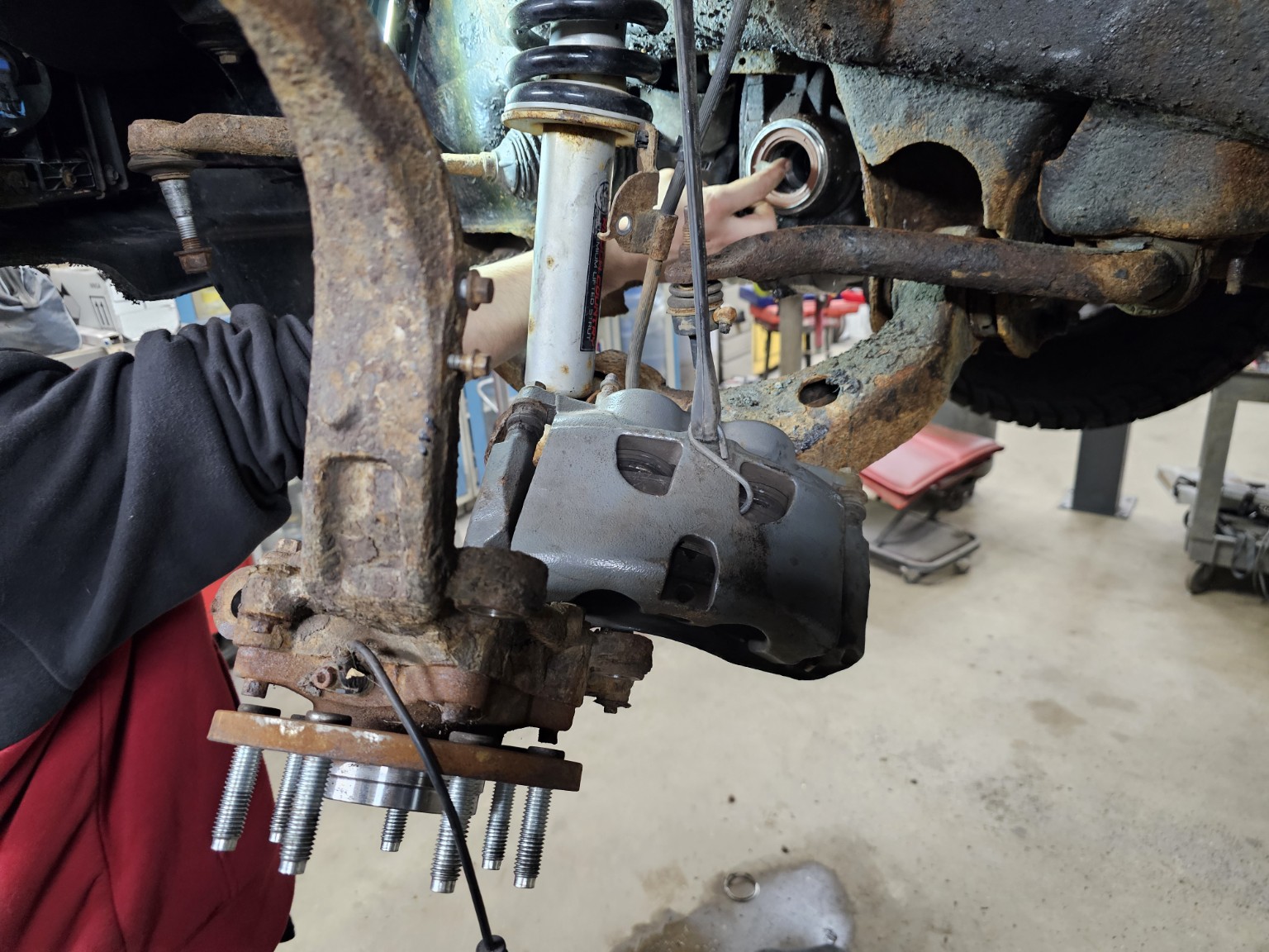 2011 Ford F-150 steering knuckle and hub disassembled for CV axle replacement
