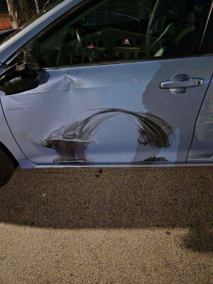 Close view of damaged Toyota Camry front and rear driver-side doors