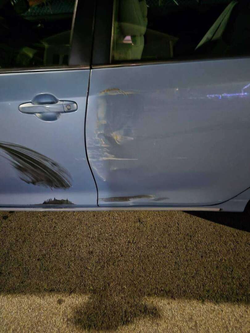 Detailed view of collision damage and creasing on Toyota Camry doors