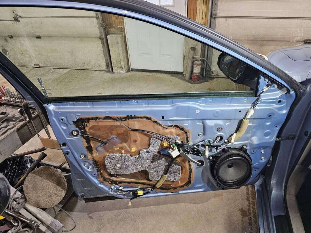 Toyota Camry door installed while wiring, glass and hardware are transferred