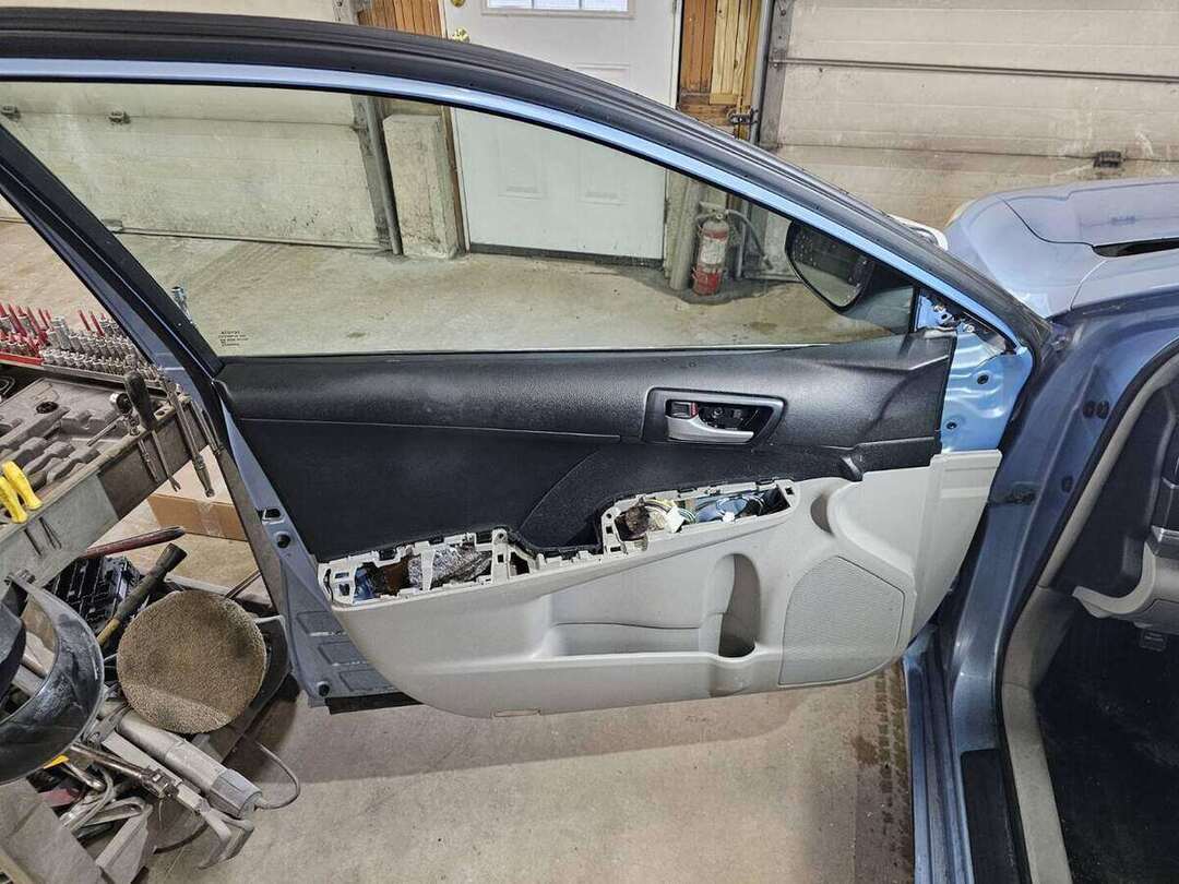 Toyota Camry interior door trim being reassembled after door replacement
