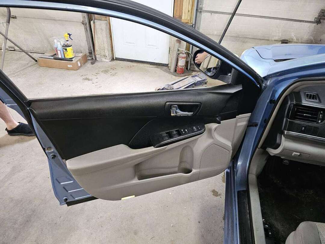 Completed Toyota Camry interior door panel after replacement and reassembly