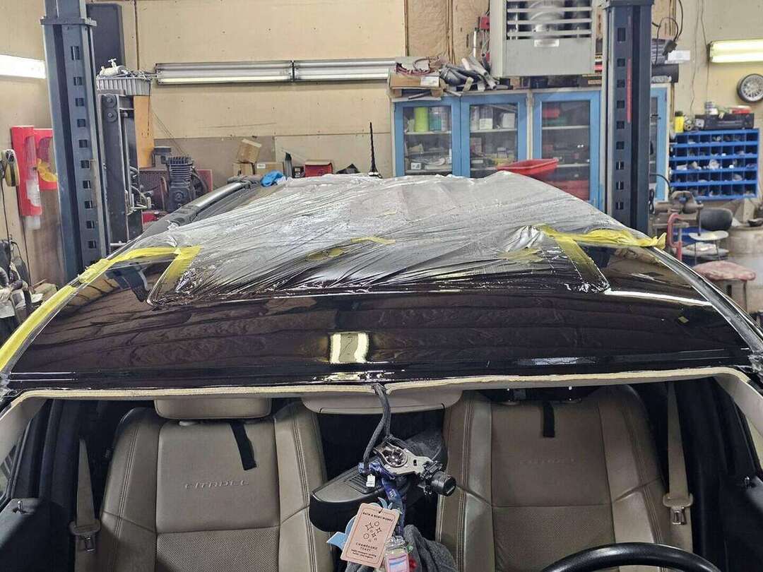 Close view of corrosion above the windshield on a Dodge Durango roof