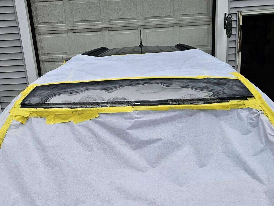 Primer applied above the windshield after Dodge Durango roof rust repair