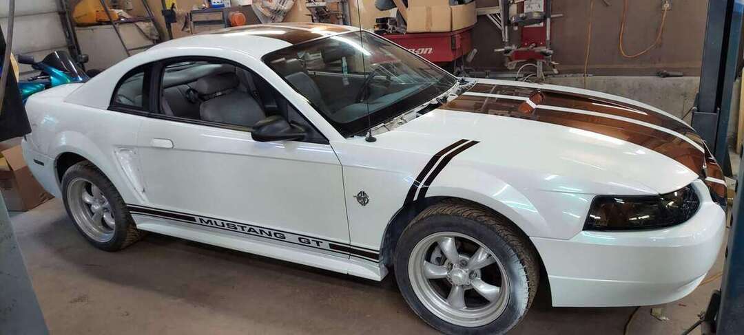 Completed white 1999 Mustang GT with burgundy center stripes