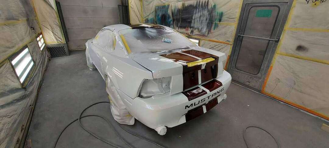 Rear three-quarter view of the Mustang during paint work