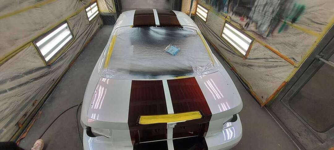 Burgundy center stripes aligned along the Mustang body